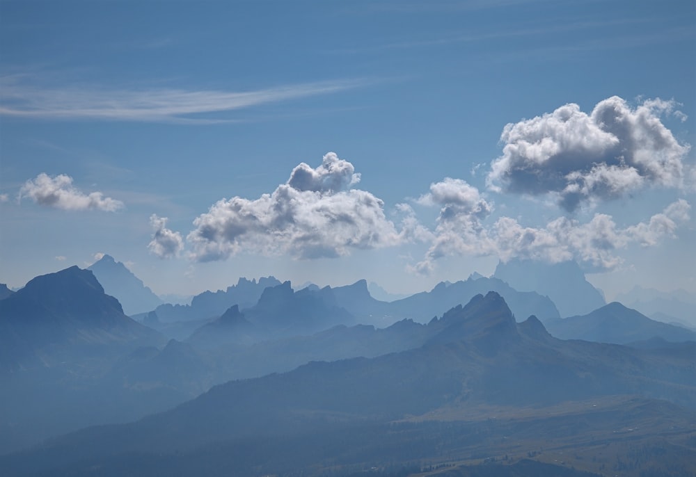 a view of a mountain range with clouds in the sky