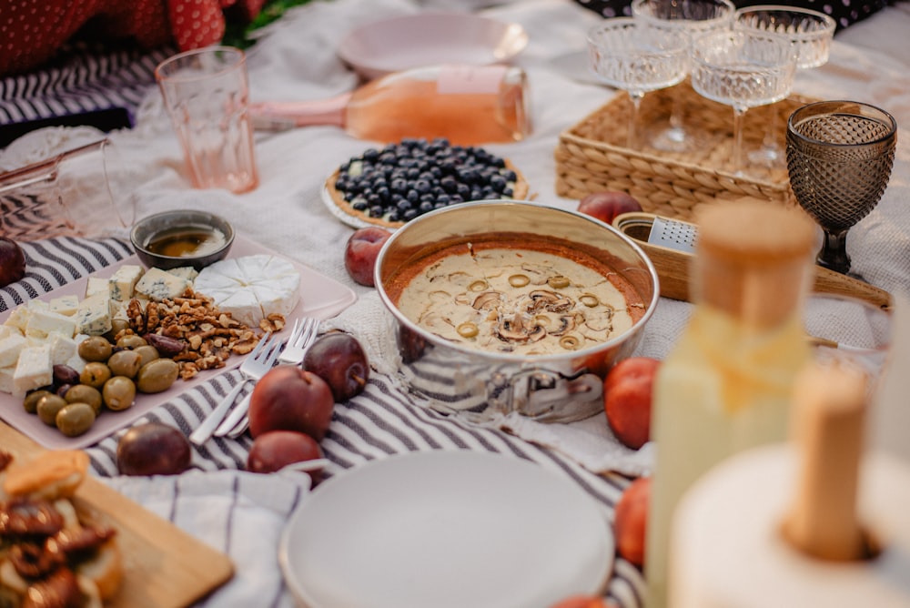 a table topped with plates and bowls of food