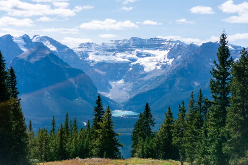 a scenic view of a mountain range with a lake in the foreground