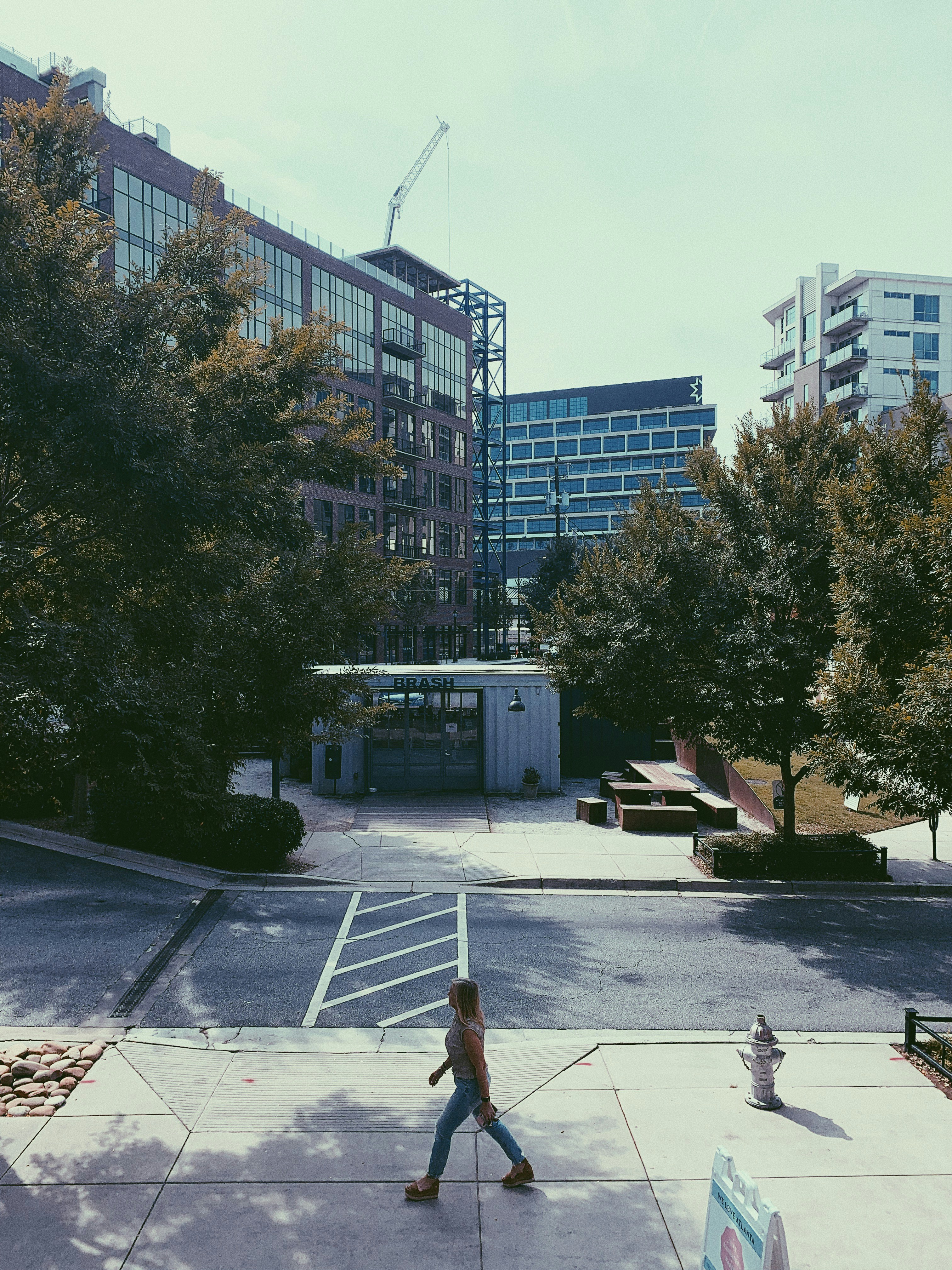 Woman walking past Westside Atlanta buildings during daytime