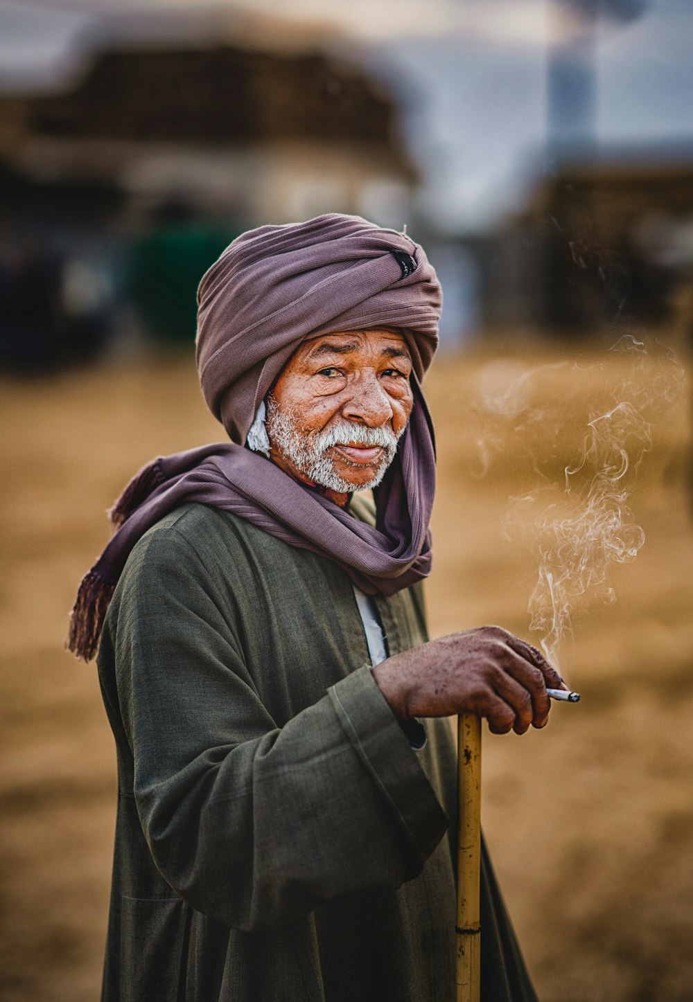 a man in a turban smoking a cigarette