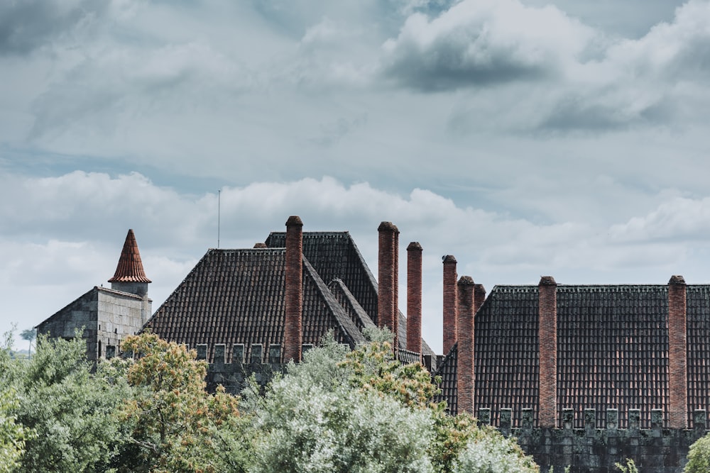 a row of brick buildings with a cloudy sky in the background
