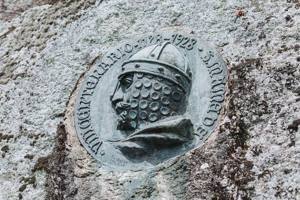 a stone plaque with a helmet on it
