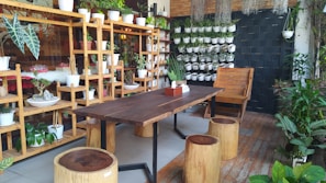 Bright, cozy common area with wooden furniture and plants at Solid Pine.