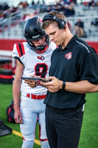 man in black and red nike jersey shirt holding black and red game controller