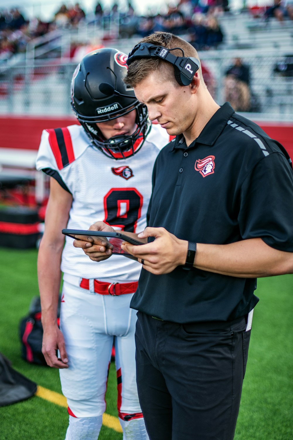 man in black and red nike jersey shirt holding black and red game controller