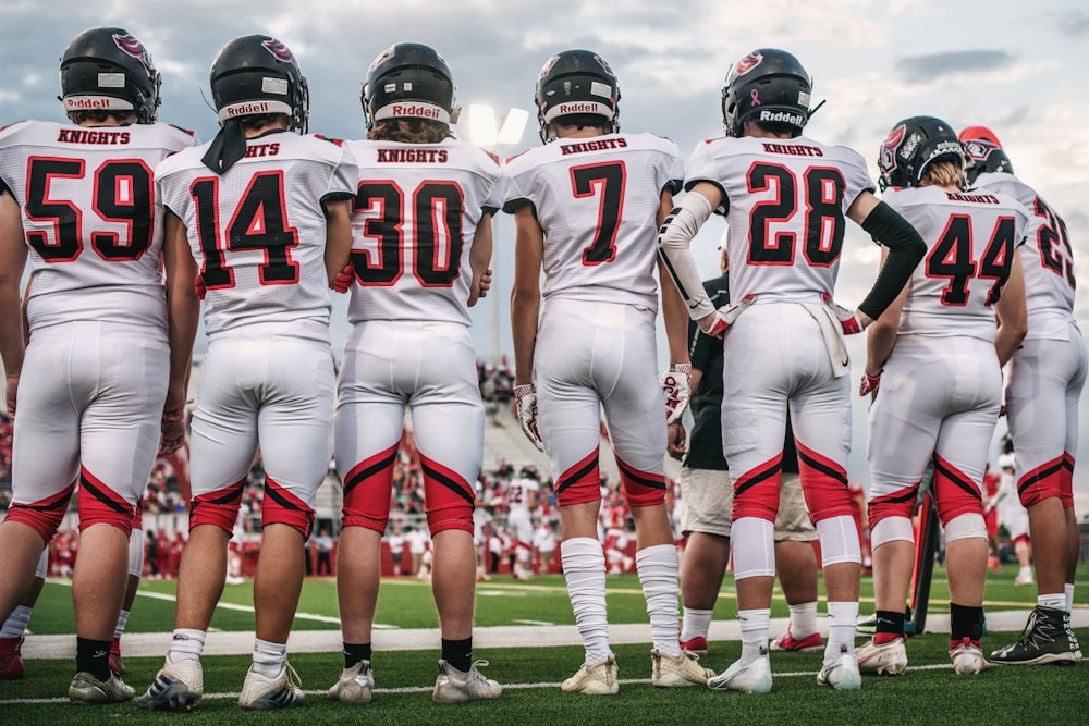 football players on green grass field during daytime