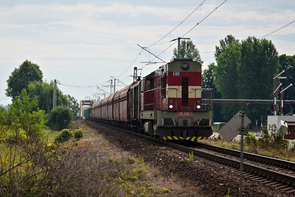 red and black train on rail tracks during daytime