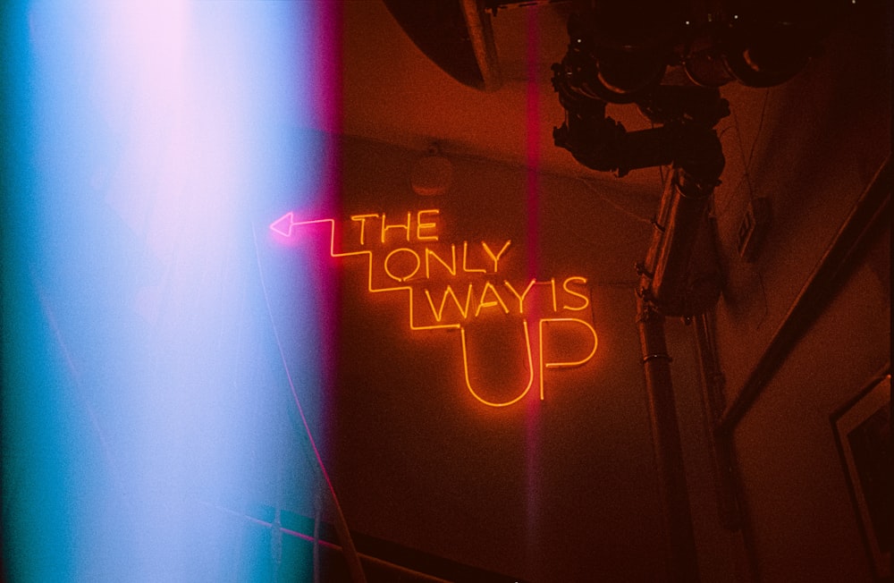 a neon sign that says the only way is up