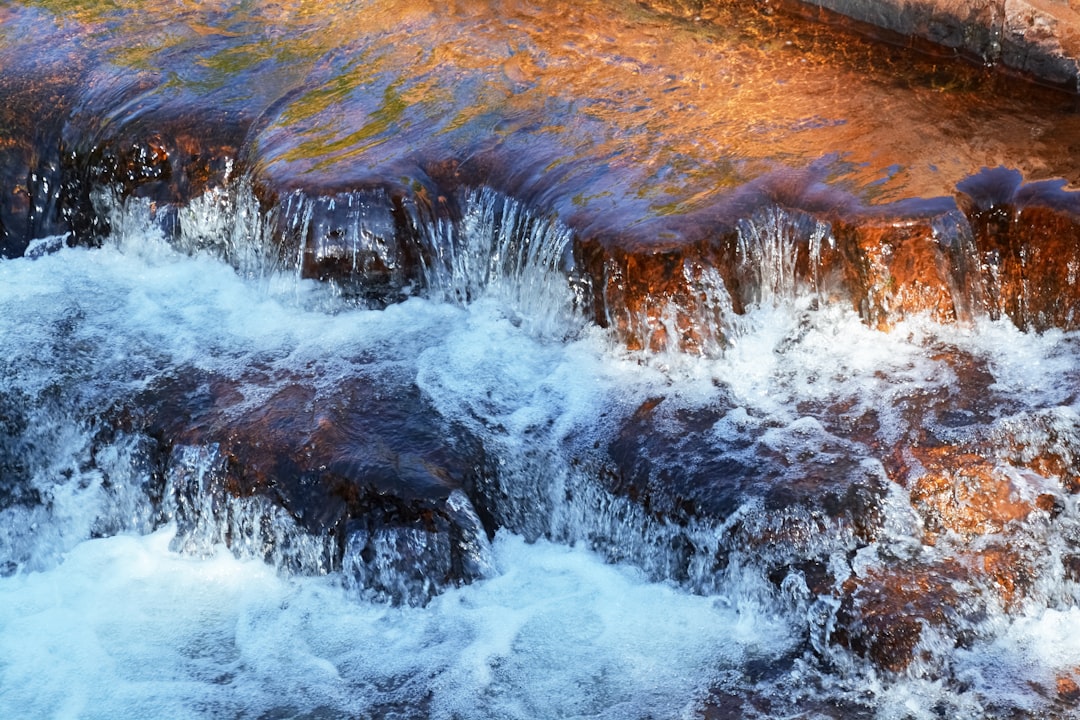 water waves hitting brown rock