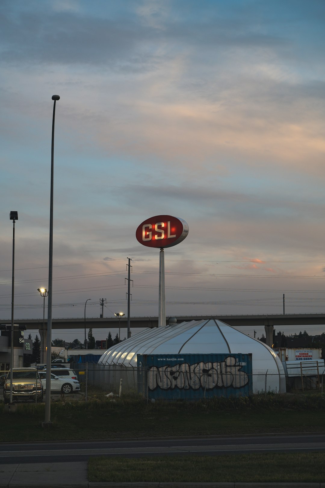 cars parked near white and blue dome building during daytime