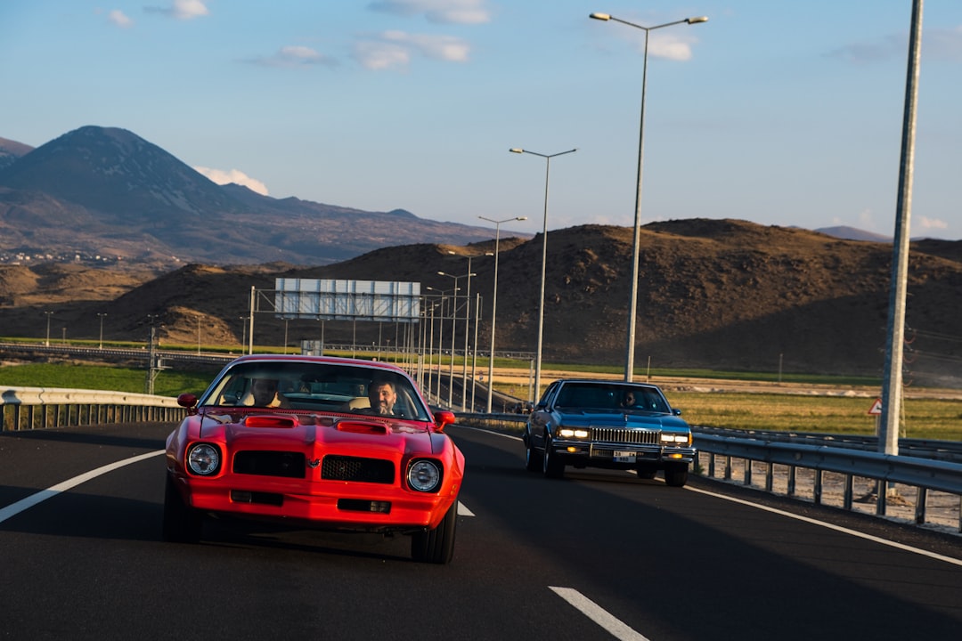 red car on road during daytime