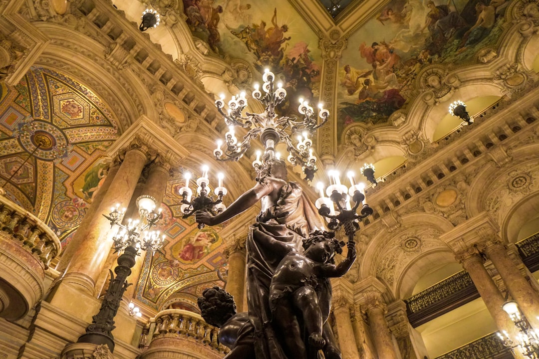 gold and white chandelier turned on inside building