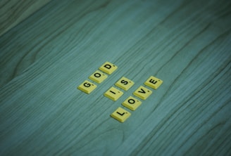the word love spelled with scrabbles on a wooden surface