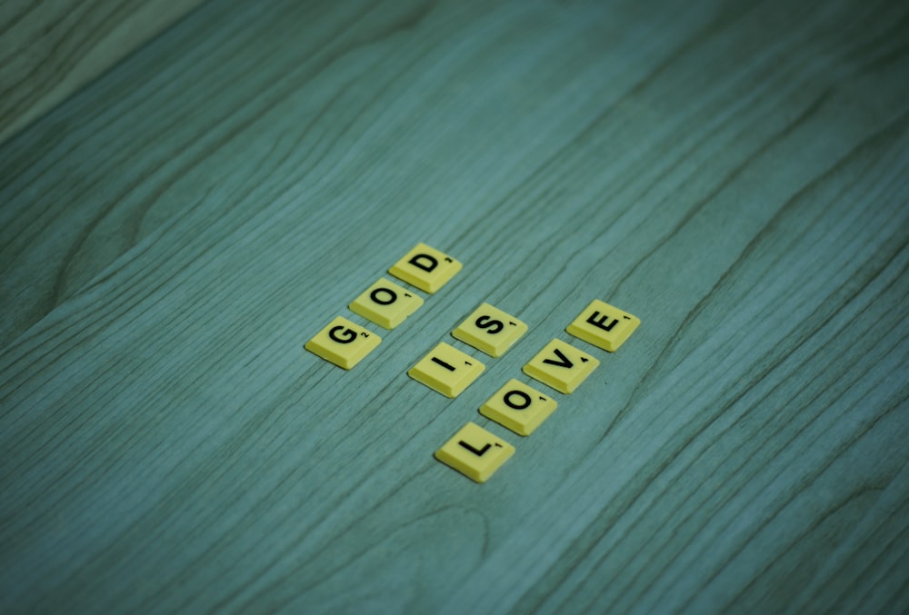 the word love spelled with scrabbles on a wooden surface