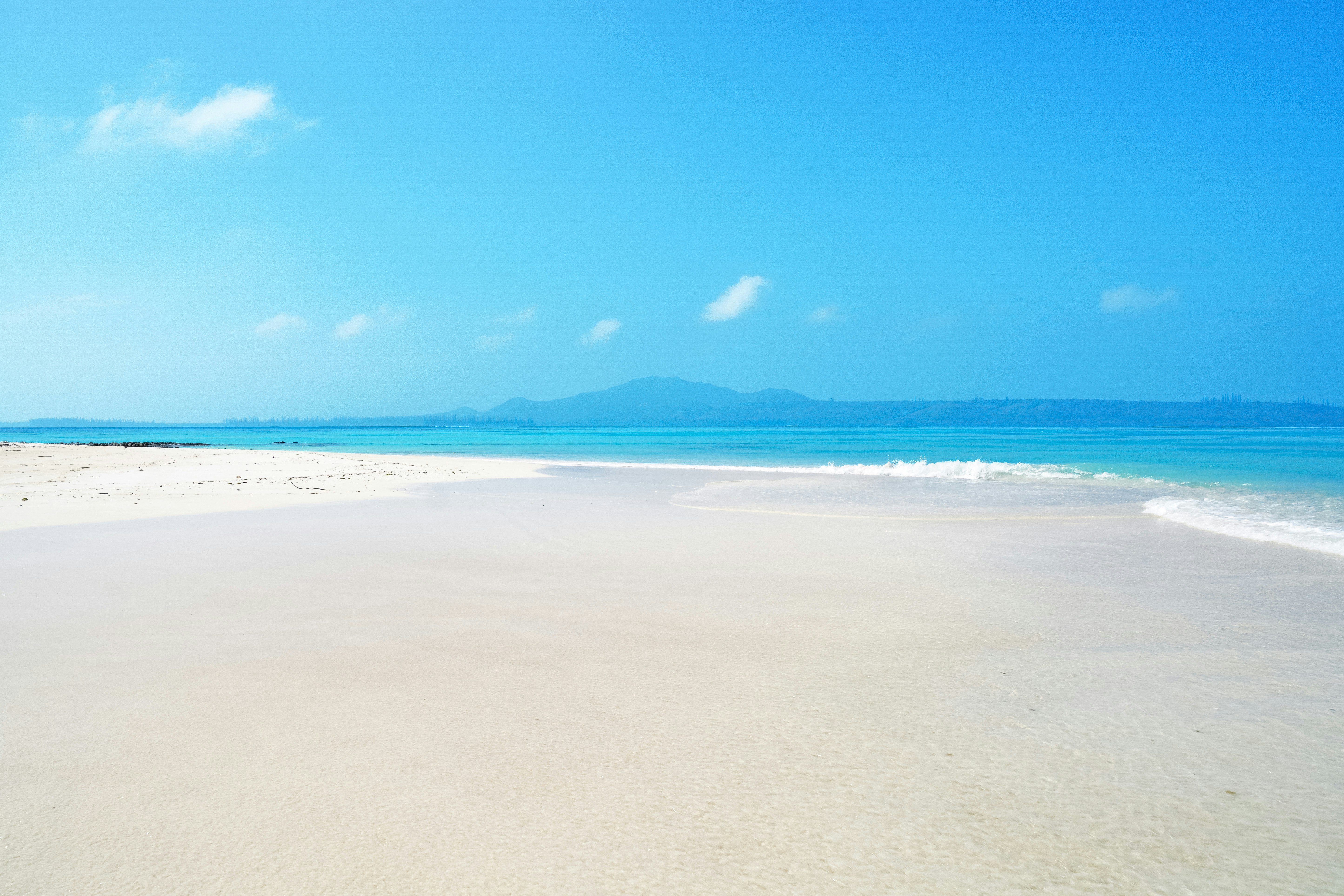 white sand beach under blue sky during daytime