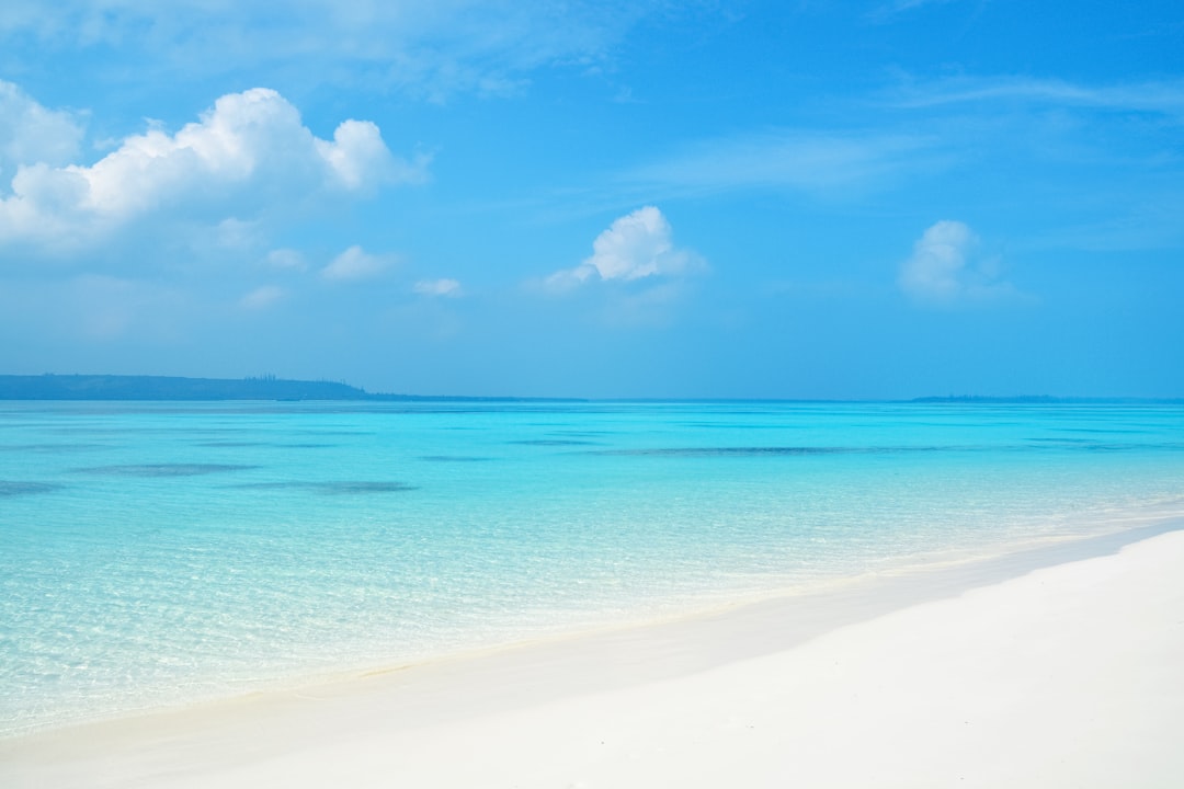 blue sea under blue sky and white clouds during daytime