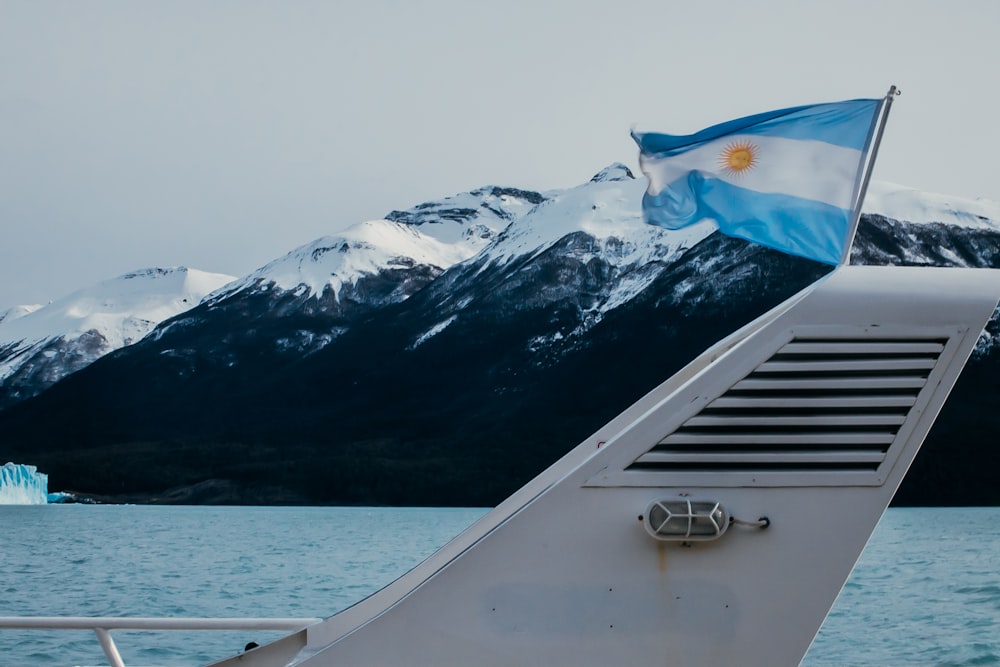 a blue and white flag on the side of a boat