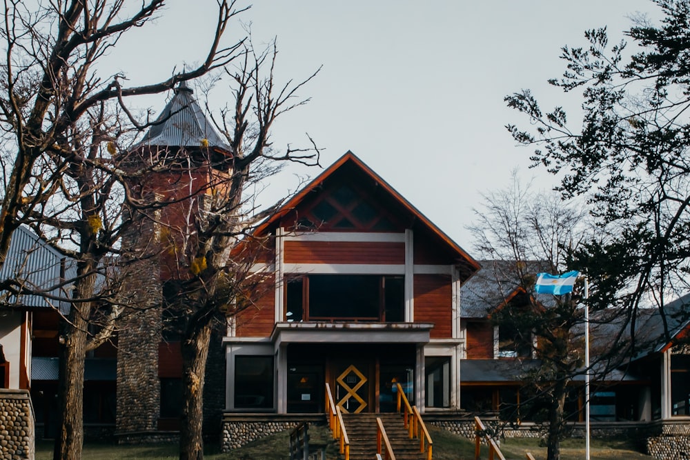 a wooden house with stairs leading up to it