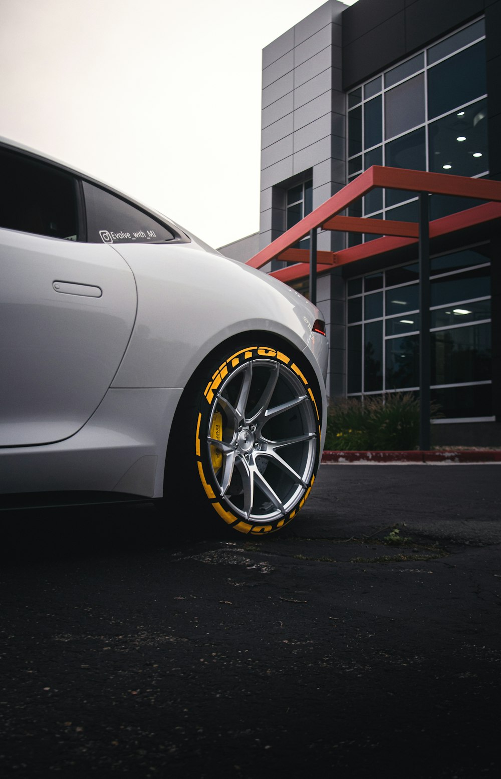 a white car parked in front of a building