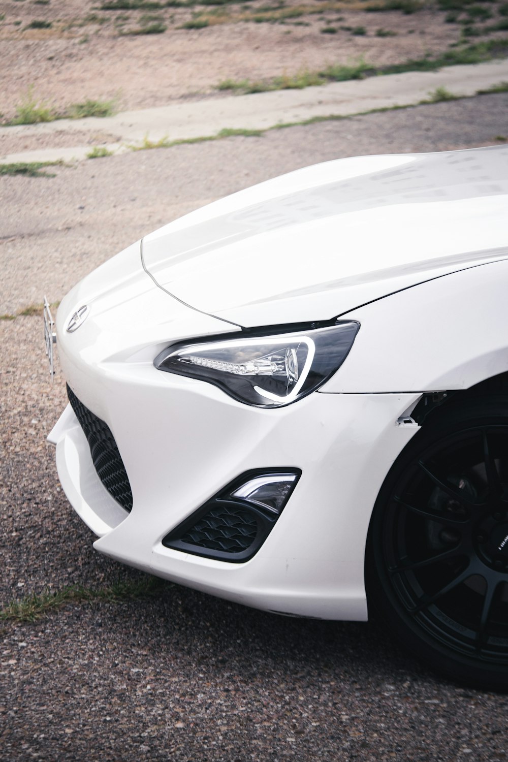 a white sports car parked in a parking lot