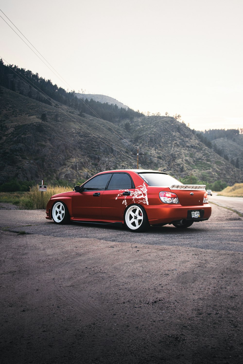 a red car parked on the side of a road