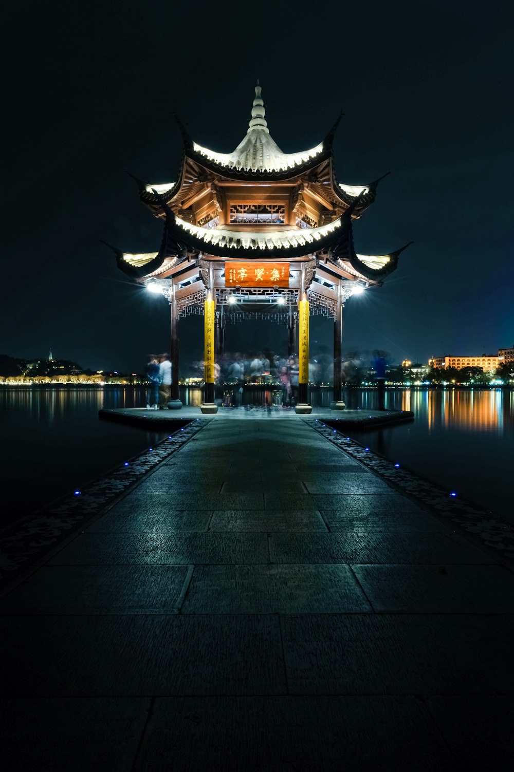 brown and white concrete building near body of water during night time