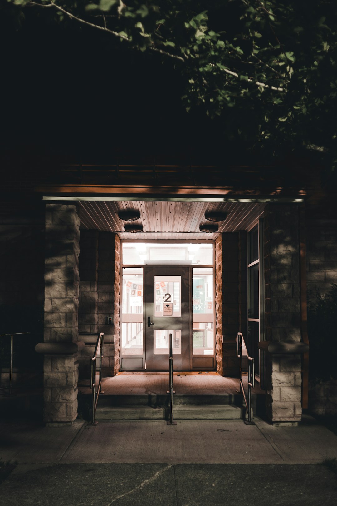 brown brick building with white wooden door