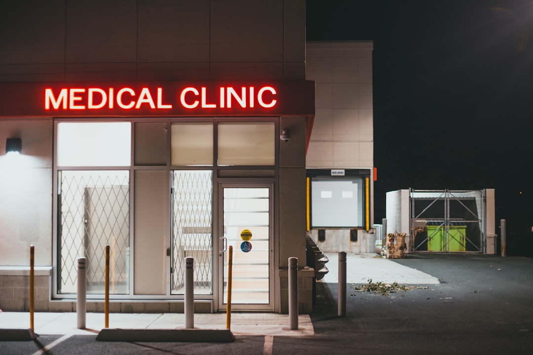 Small medical clinic storefront lit up at night