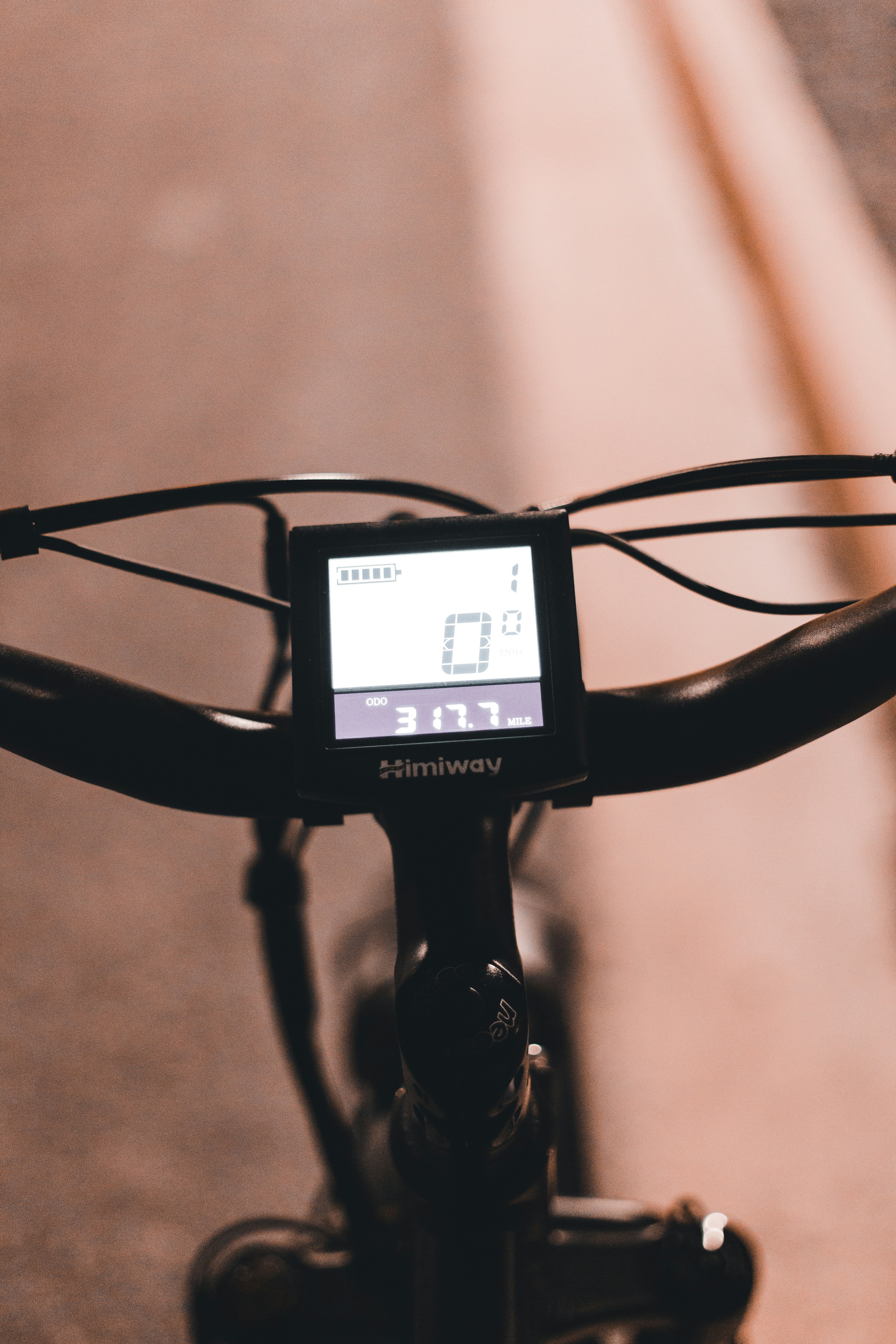 Close-up of electric bike motor and battery system being inspected by a technician with diagnostic tools