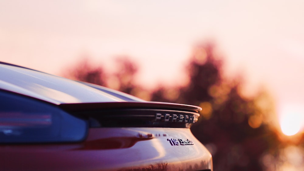 a close up of a car with trees in the background