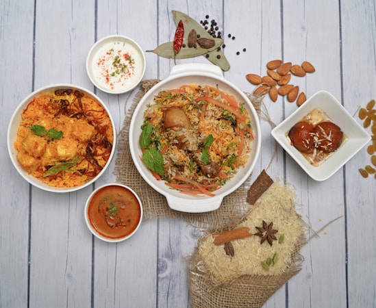 a table topped with bowls of food and sauces