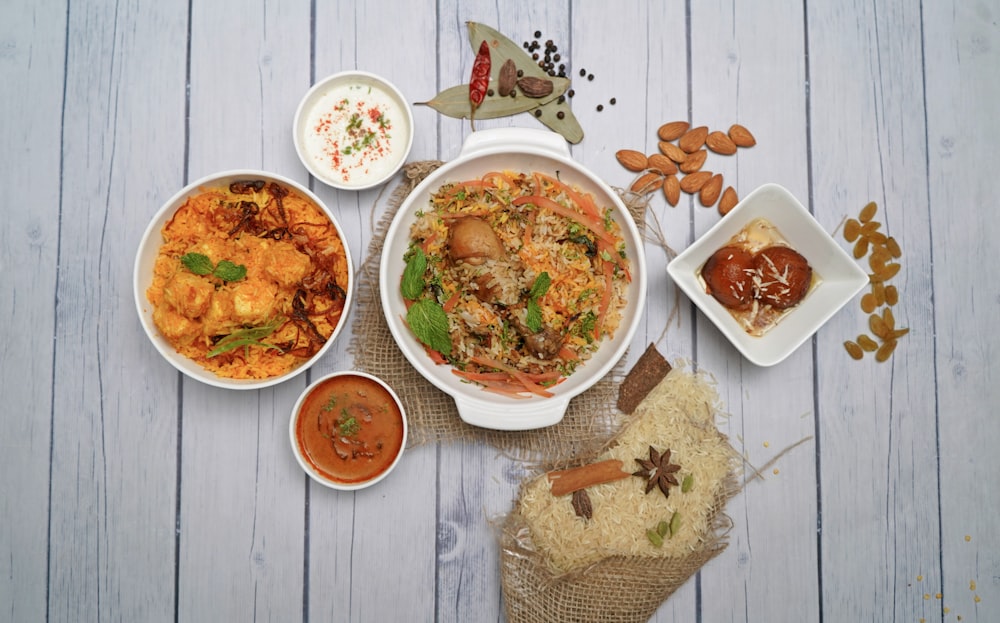 a table topped with bowls of food and sauces