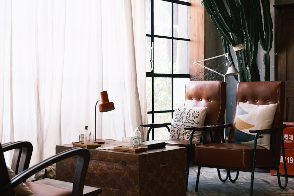 brown wooden table near brown and white floral armchair