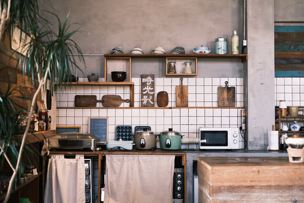 white microwave oven on brown wooden shelf