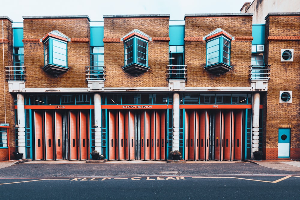 blue and brown wooden windows on gray concrete building during daytime