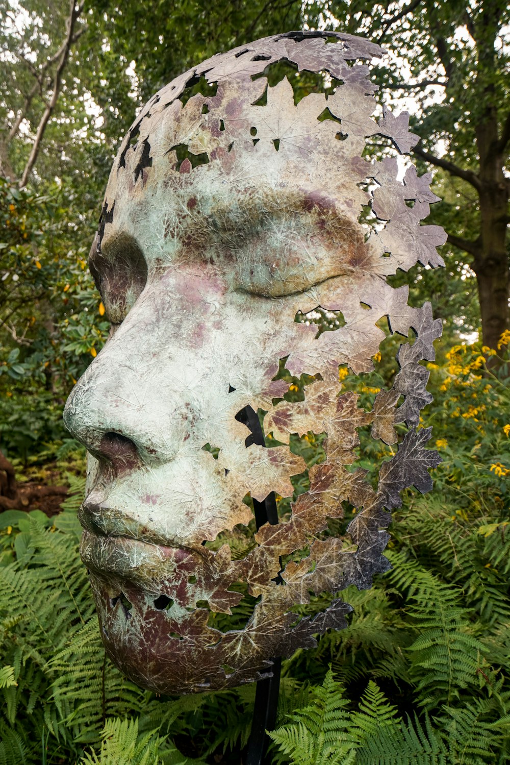 white and black skull with yellow flowers on head