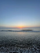 Calm ocean view at sunrise with soft natural light.