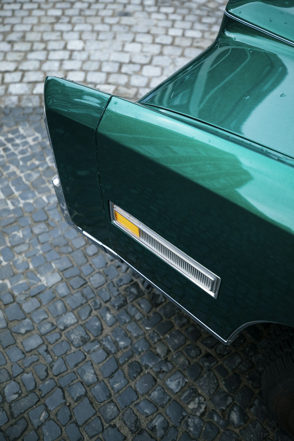 green car on gray concrete pavement