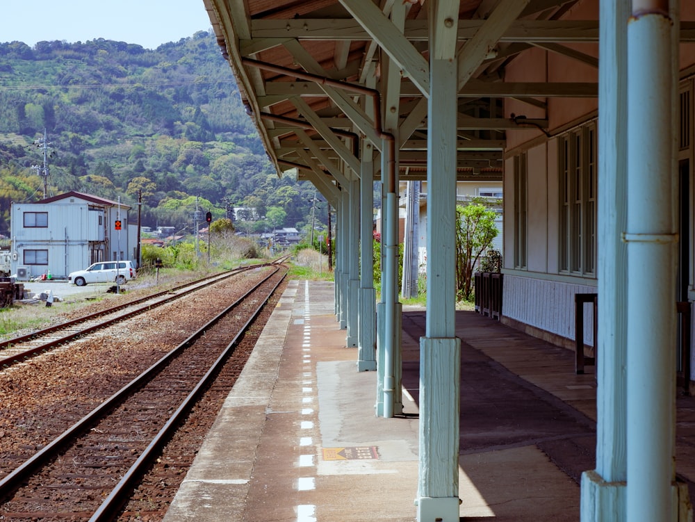 a train station with a train on the tracks