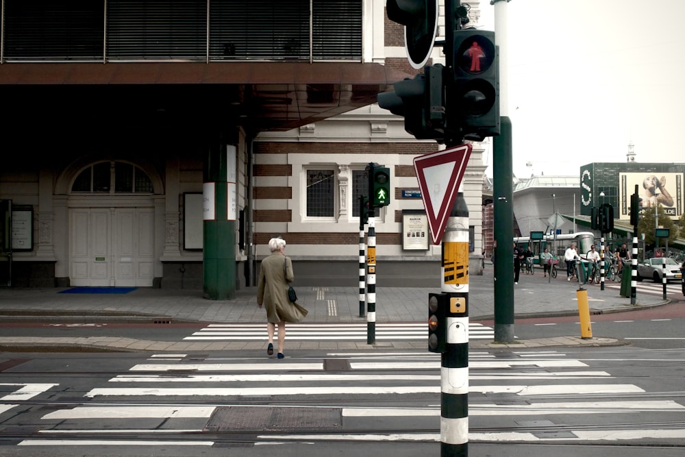 a woman crossing the street at a crosswalk