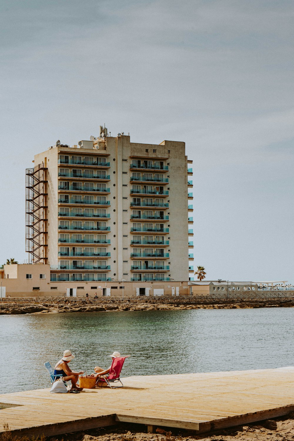 Edificio de hormigón marrón cerca de un cuerpo de agua durante el día