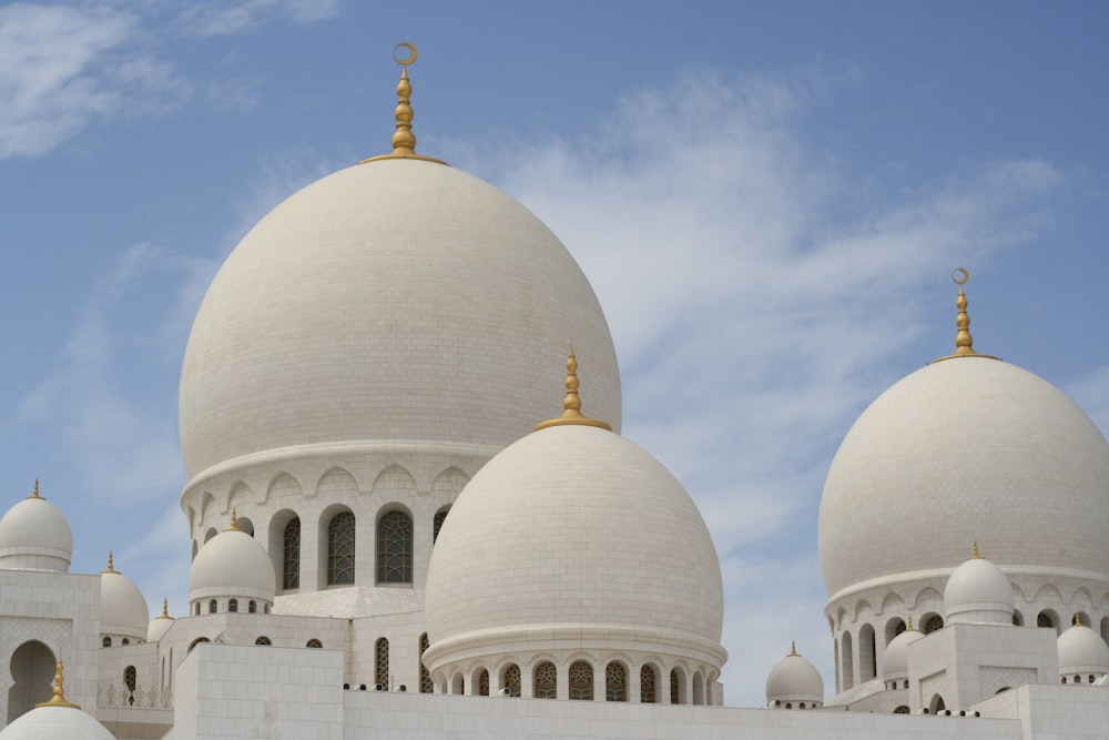 a large white building with three domes on top of it
