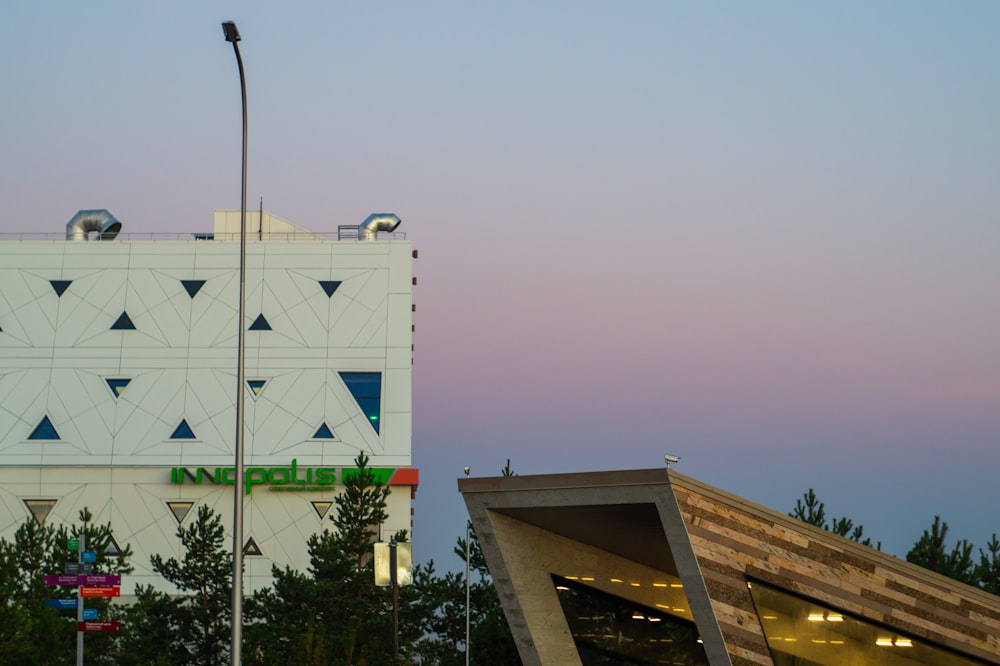 a tall white building sitting next to a traffic light