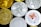 A collection of various cryptocurrency coins featuring different designs and logos. Some coins are gold, while others are silver, each with distinct symbols relating to their respective cryptocurrencies. There is a prominently displayed face of a Shiba Inu on one of the silver coins, reflecting the Shiba Inu cryptocurrency.
