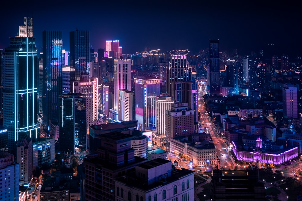 a city at night with a lot of tall buildings