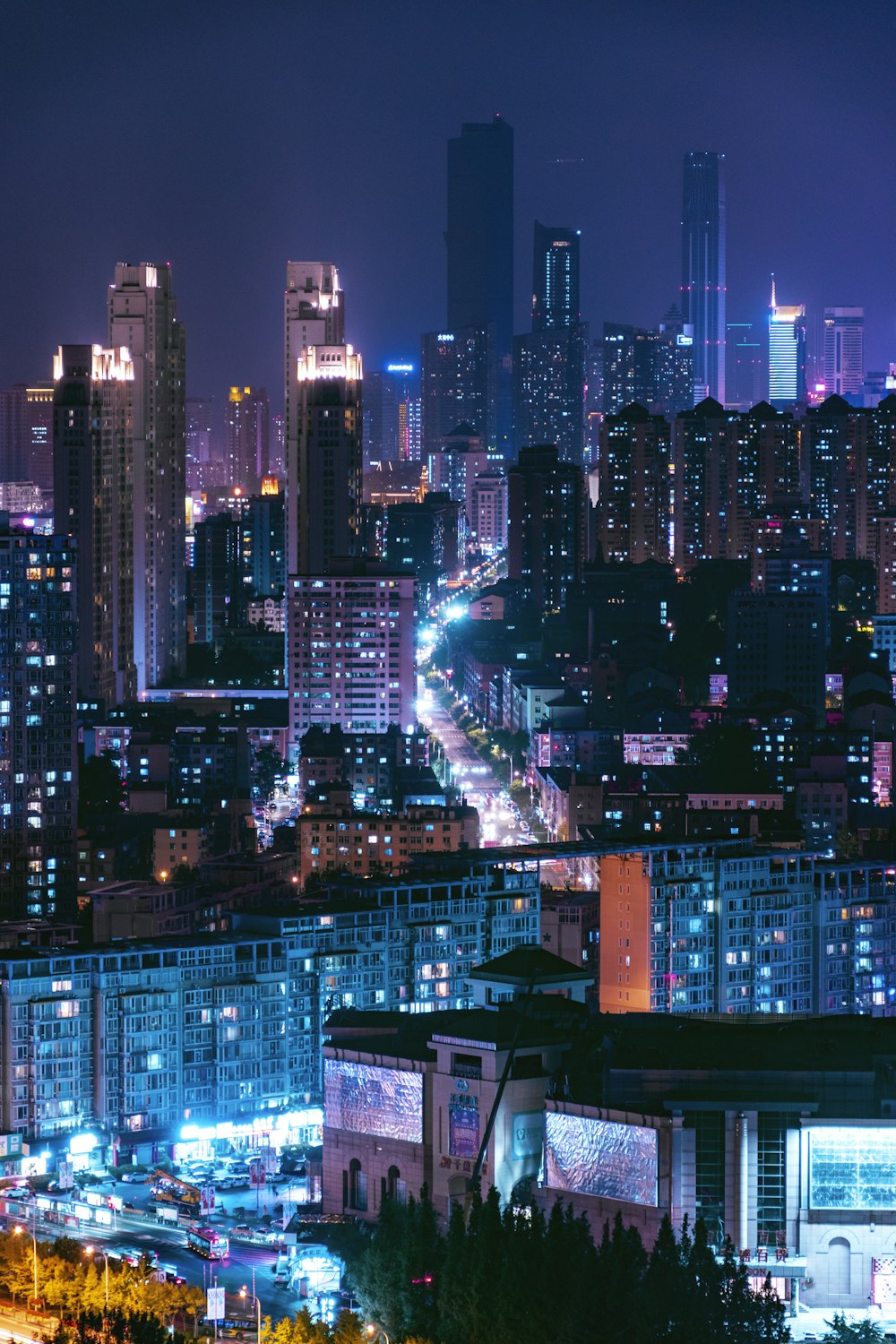 a city at night with a lot of tall buildings