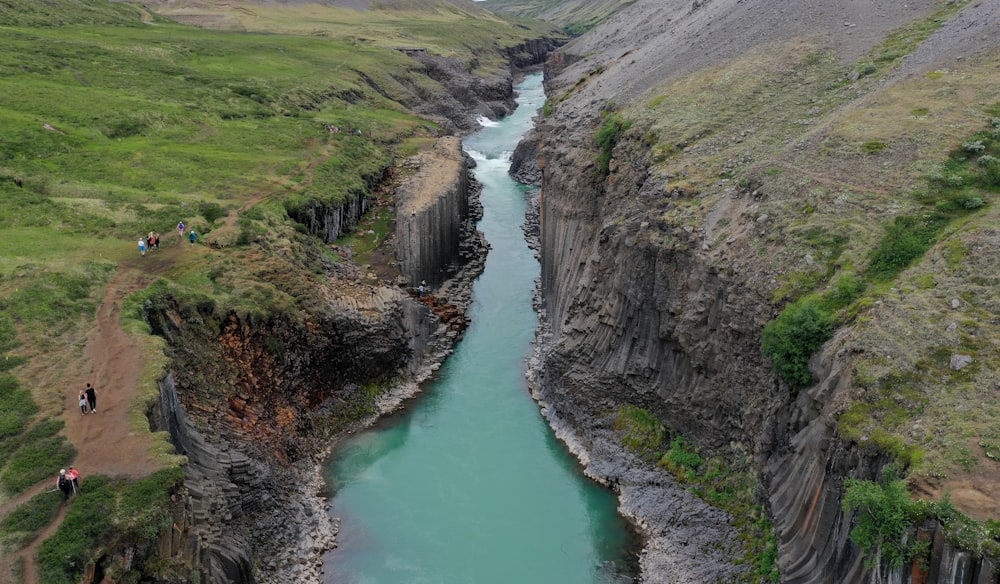 a river flowing through a lush green valley