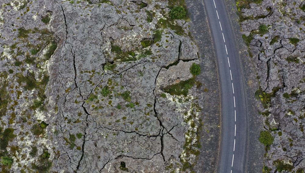 an aerial view of a road surrounded by rocks