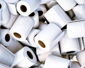 Close-up of soft white toilet paper rolls neatly stacked in a professional supply setting